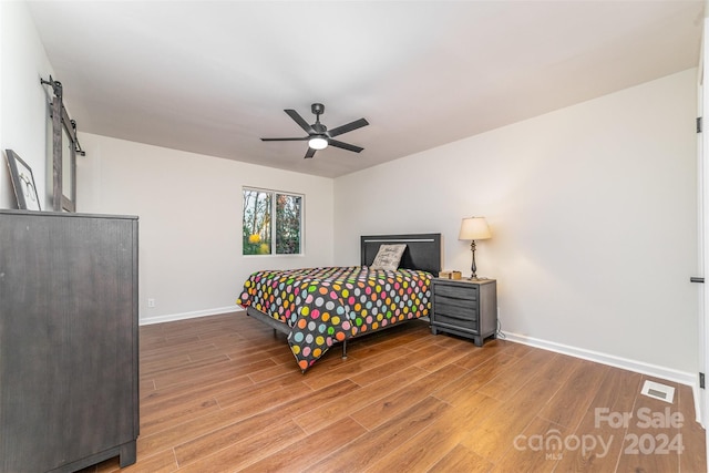 bedroom with hardwood / wood-style floors and ceiling fan