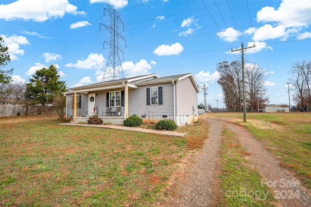 ranch-style house with covered porch and a front yard