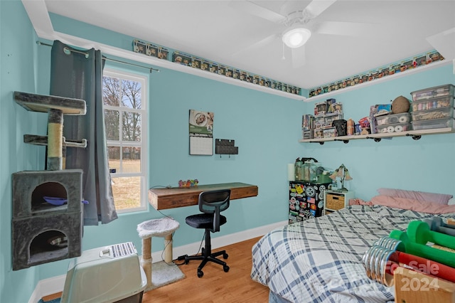 bedroom featuring multiple windows, ceiling fan, and hardwood / wood-style flooring