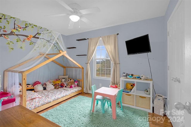 bedroom with hardwood / wood-style flooring and ceiling fan