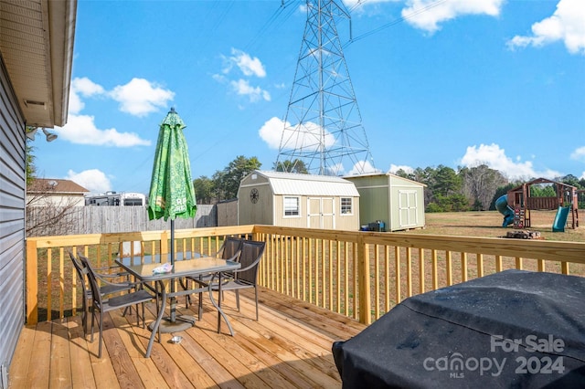 deck featuring a playground and a storage shed