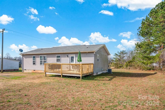 rear view of property featuring a yard, a deck, and central air condition unit