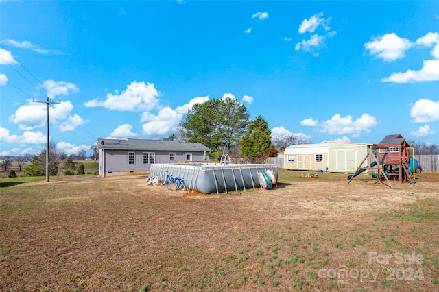 view of yard featuring a shed and a playground