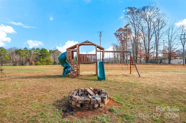 view of play area with a lawn and an outdoor fire pit