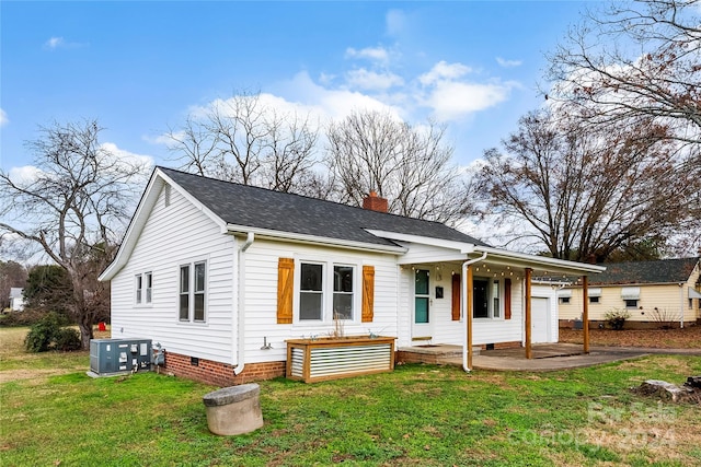 rear view of house featuring a porch, a yard, and central air condition unit