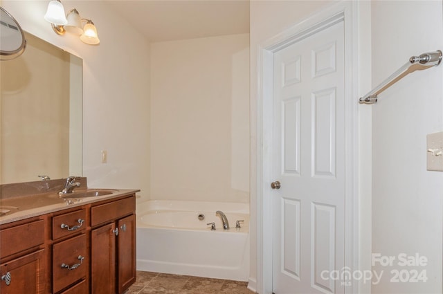 bathroom featuring a bath, vanity, and tile patterned floors