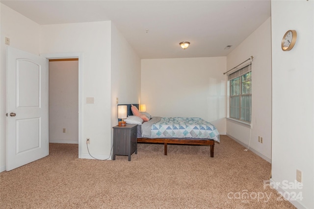 bedroom featuring light carpet