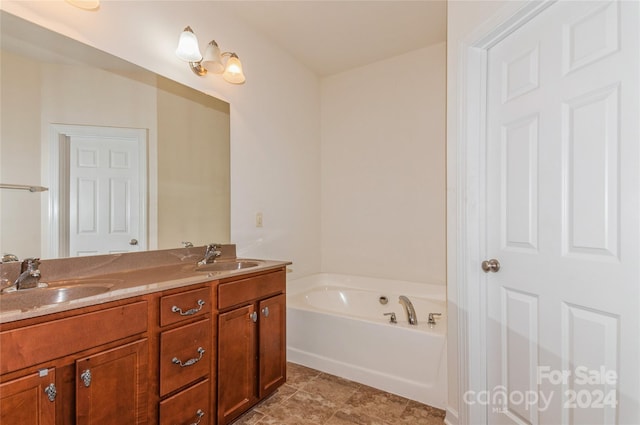 bathroom featuring vanity, tile patterned floors, and a bathtub