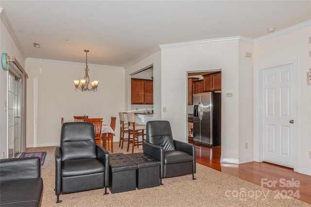 living room with crown molding, a chandelier, and hardwood / wood-style flooring