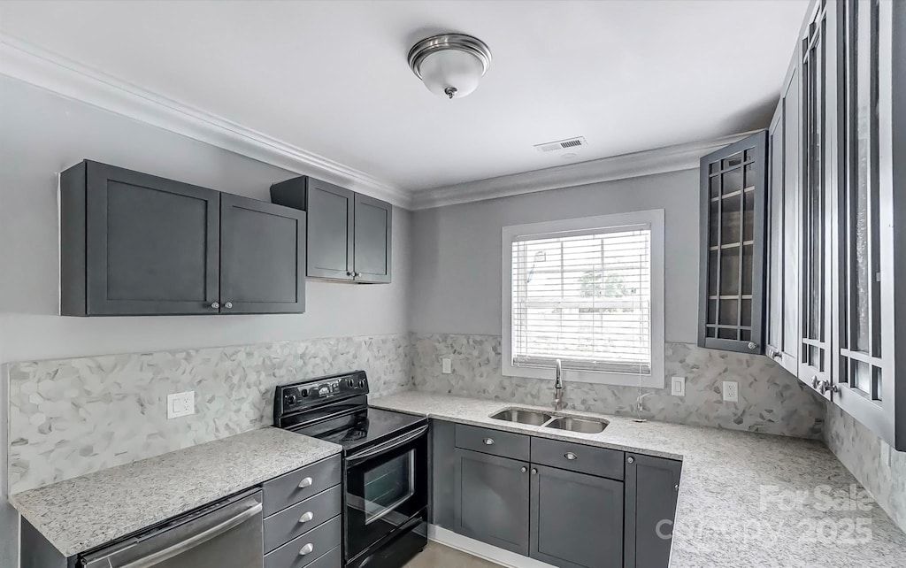 kitchen with gray cabinetry, sink, light stone counters, black / electric stove, and ornamental molding