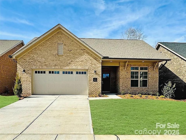 view of front of home featuring an attached garage, brick siding, a shingled roof, driveway, and a front lawn