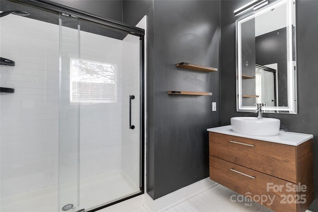 bathroom with tile patterned flooring, vanity, and an enclosed shower