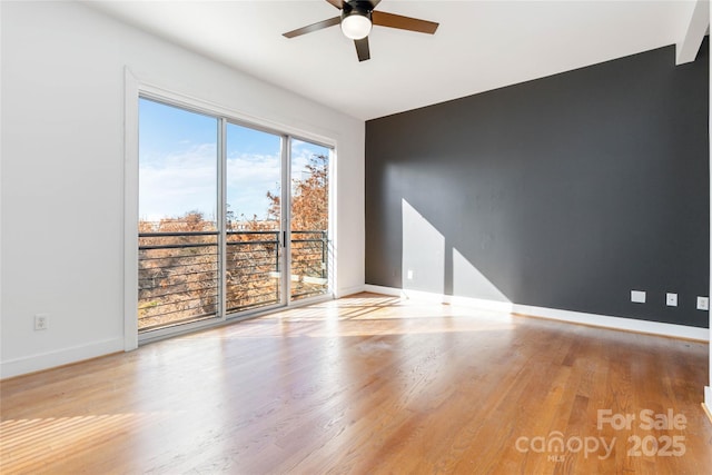 empty room with light hardwood / wood-style flooring and ceiling fan