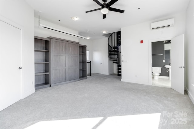 unfurnished living room featuring ceiling fan, light colored carpet, and a wall unit AC