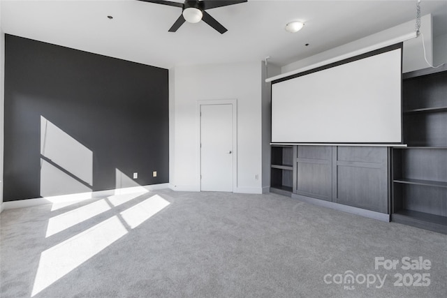 home theater room with light colored carpet and ceiling fan