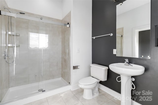 bathroom with tile patterned flooring, toilet, an enclosed shower, and sink