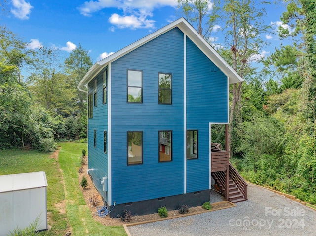 view of side of home featuring a lawn