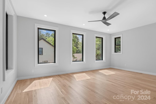 empty room featuring ceiling fan and light hardwood / wood-style flooring