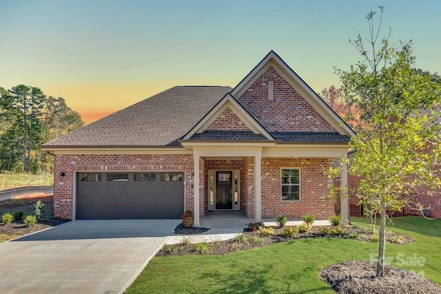 craftsman house with a yard and a garage