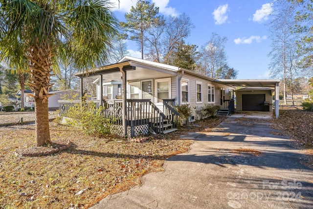 view of front of house featuring covered porch and a carport