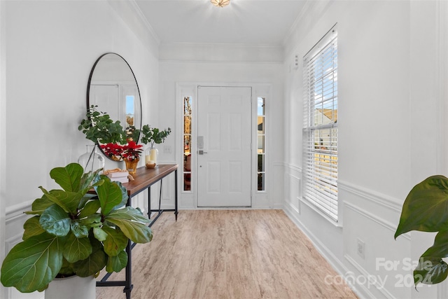 entryway featuring light hardwood / wood-style floors and ornamental molding