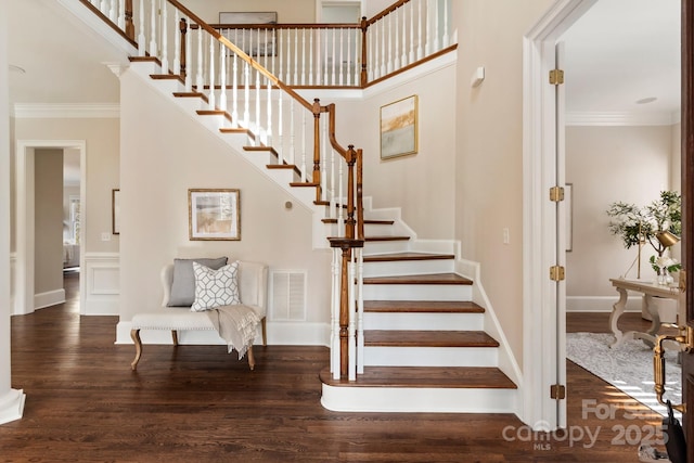 stairway featuring ornamental molding and hardwood / wood-style flooring