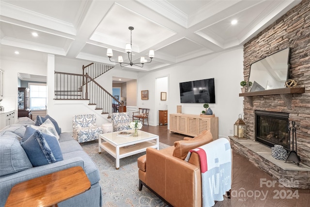 living room featuring an inviting chandelier, coffered ceiling, crown molding, a fireplace, and beamed ceiling