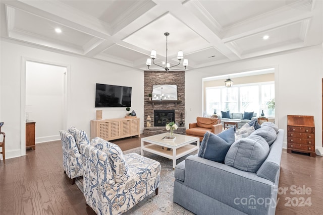 living room featuring dark wood-type flooring, coffered ceiling, a fireplace, beamed ceiling, and a notable chandelier