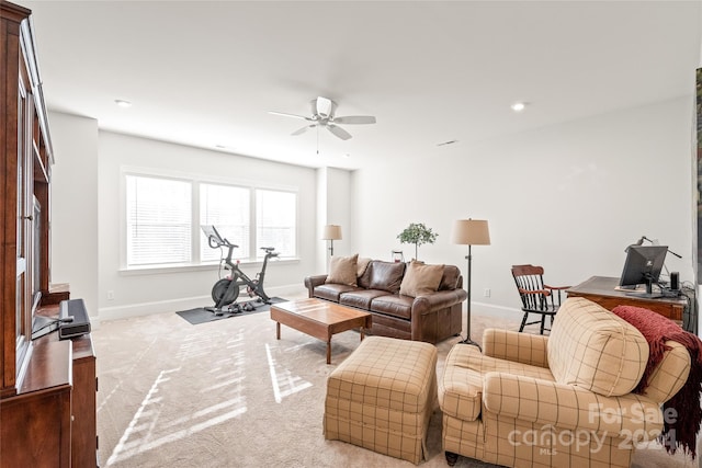 carpeted living room featuring ceiling fan