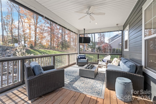 wooden deck featuring outdoor lounge area and ceiling fan