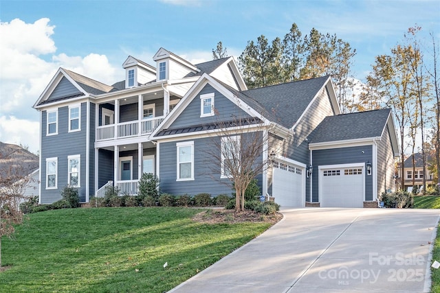 view of front of home featuring a porch, concrete driveway, a garage, a balcony, and a front yard