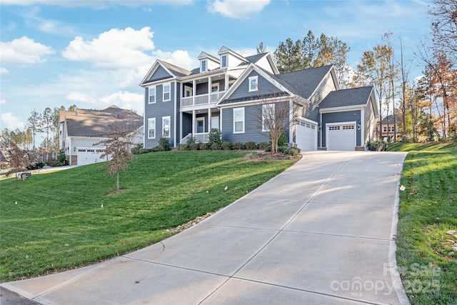 view of front of home with an attached garage, driveway, a balcony, and a front yard
