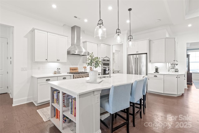 kitchen featuring backsplash, light countertops, high end refrigerator, wall chimney exhaust hood, and white cabinetry