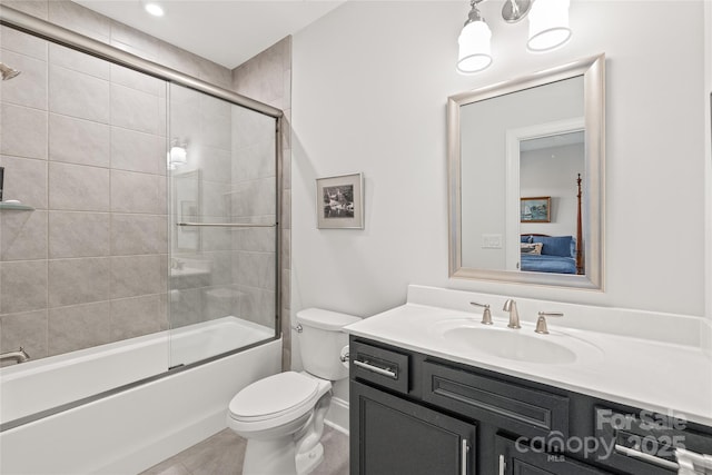 ensuite bathroom featuring toilet, tile patterned flooring, combined bath / shower with glass door, vanity, and connected bathroom