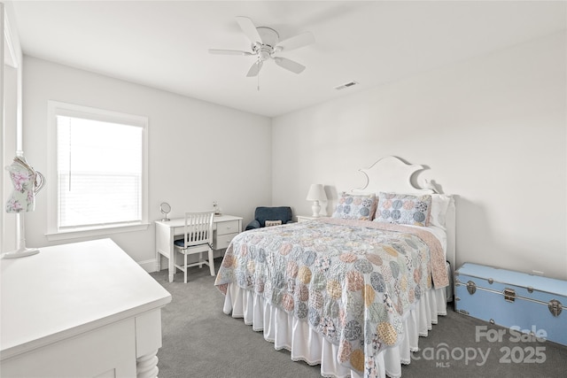 carpeted bedroom featuring a ceiling fan and visible vents