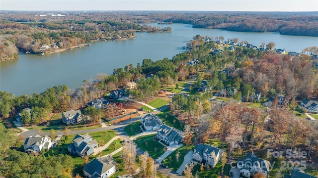 bird's eye view with a view of trees, a residential view, and a water view