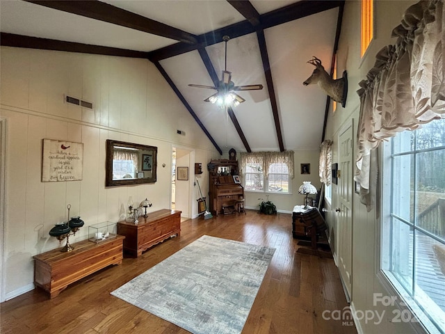 living room with beam ceiling, dark hardwood / wood-style floors, high vaulted ceiling, and ceiling fan