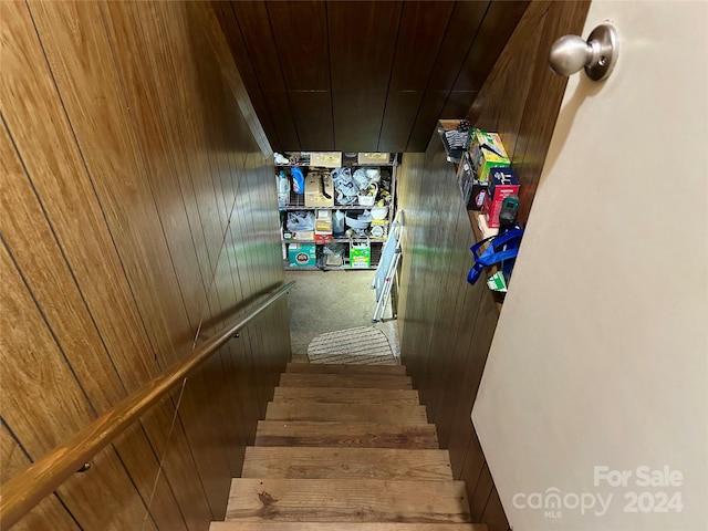 stairs featuring wooden walls