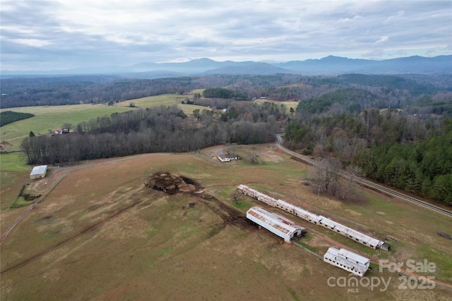 drone / aerial view featuring a mountain view and a rural view
