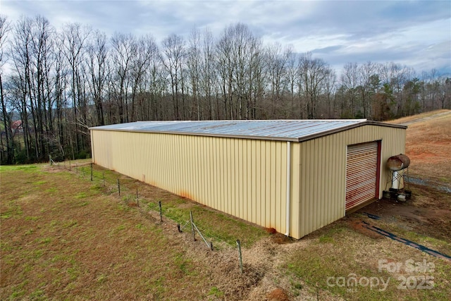 view of pole building featuring a wooded view