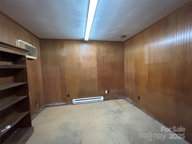 below grade area featuring a baseboard radiator and wood walls