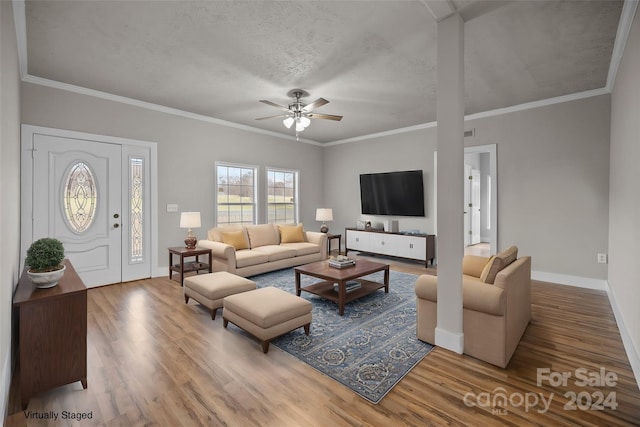 living room featuring crown molding, ceiling fan, a textured ceiling, and hardwood / wood-style flooring