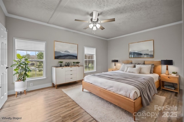 bedroom with ornamental molding, a textured ceiling, and light wood-type flooring