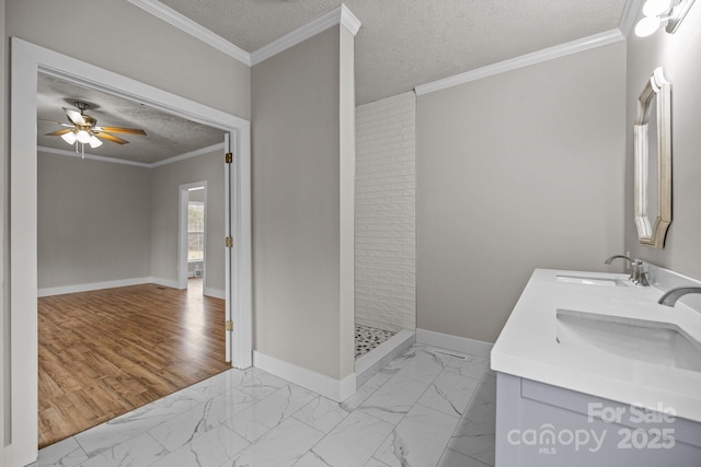 bathroom featuring ornamental molding, a shower, vanity, and a textured ceiling