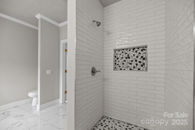 bathroom with crown molding, toilet, a textured ceiling, and a tile shower