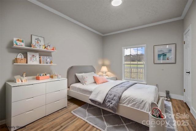 bedroom featuring crown molding, hardwood / wood-style floors, and a textured ceiling