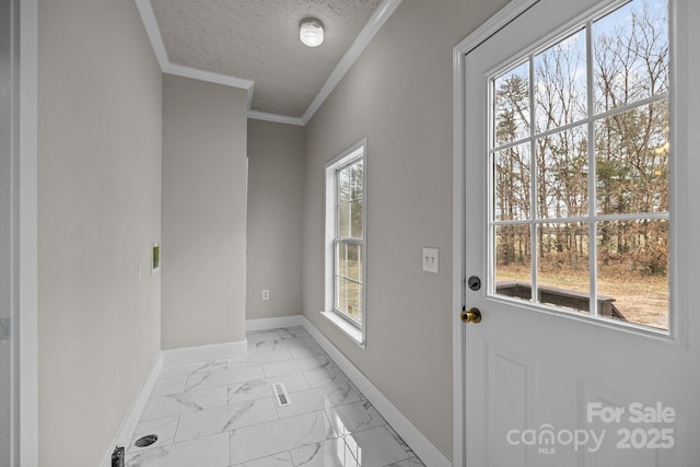 doorway with crown molding and a textured ceiling