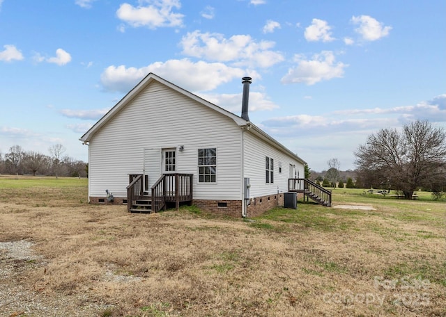 view of home's exterior with cooling unit and a lawn