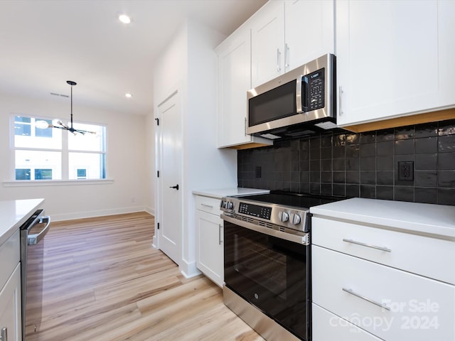 7022 Impulse Ct, Charlotte, NC 28205 - kitchen featuring stainless steel appliances, light wood finished floors, light countertops, recessed lighting, and white cabinets