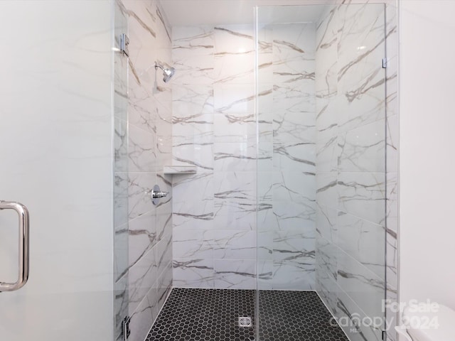 bathroom featuring a shower with door